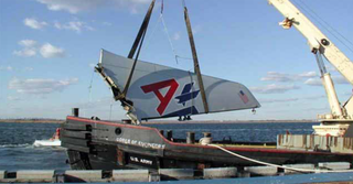 A US Army Corps of Engineers recovery vessel raises the vertical stabilizer from Jamaica Bay (US Government)